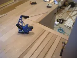 Flooring installation tools laid out on hardwood